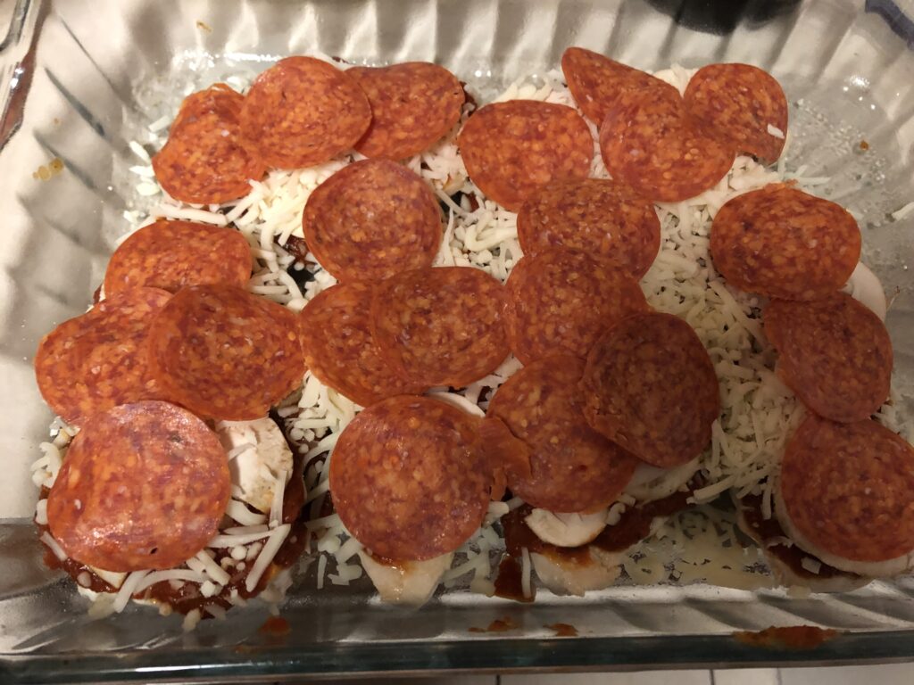 Low carb keto friendly pepperoni mushroom pizza chicken with a layer of mozzarella and pepperoni